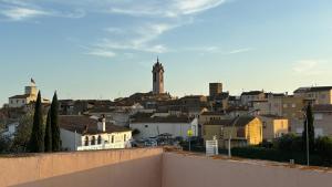 a view of a city with a clock tower at Ca La Botera in Verges