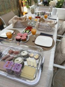 a long table filled with food and orange juice at Casa La Nuez in Almedinilla