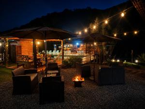 a patio with chairs and umbrellas at night at Estação Serramar in Lumiar