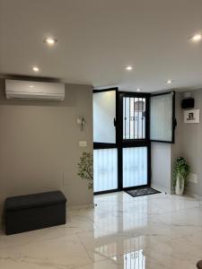 a living room with a large glass door and a couch at La 75 Stella Home Catania in Catania