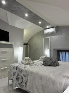 a bedroom with a bed with towels on it at La 75 Stella Home Catania in Catania