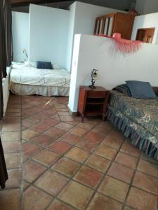 a room with two beds and a tiled floor at Large studio with private patio in Casa Cornucopia in San José del Cabo
