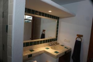a bathroom with a sink and a mirror at Large studio with private patio in Casa Cornucopia in San José del Cabo +8 photos