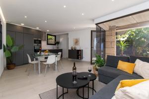 a living room with a couch and a table at Infinity House. Ocean View hot tub. in Adeje
