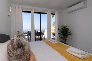 a bedroom with a bed with a view of the ocean at Infinity House. Ocean View hot tub. in Adeje +34 photos