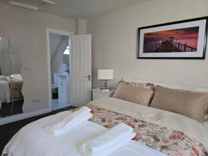 a bedroom with a bed with two towels on it at Dreams and Homes in Dublin- Entire home in Hartstown +10 photos