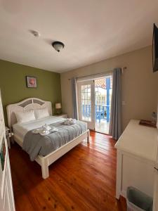 a bedroom with a bed and a sliding glass door at Hotel Bocas Town in Bocas Town +19 photos