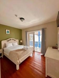 a bedroom with a bed and a sliding glass door at Hotel Bocas Town in Bocas Town