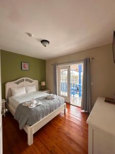 a bedroom with a bed and a sliding glass door at Hotel Bocas Town in Bocas Town
