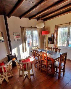 a dining room with a table and chairs at Finca La Penúltima-Posada in San Rafael