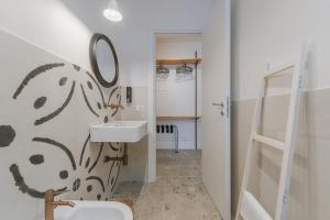 a bathroom with a sink and a mirror at Casa Ritunno Rooms in Favignana