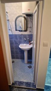a bathroom with a sink and a mirror at Apartmani MULIC Sutomore in Sutomore