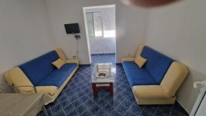 a living room with two couches and a table at Apartmani MULIC Sutomore in Sutomore +5 photos