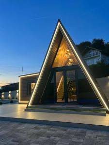 a house with a pyramid shaped roof with lights at A-Frame Villa - Kovačević Hills in Velika Kladuša