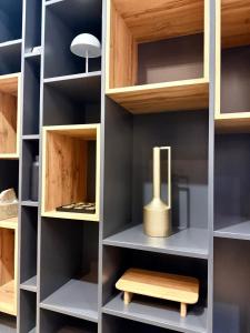 a closet with wooden shelves and a wooden stool at A-Frame Villa - Kovačević Hills in Velika Kladuša +10 photos