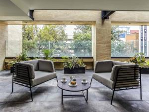 two chairs and a coffee table in a lobby at Novotel México City Centro Histórico in Mexico City