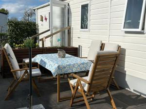 a table and chairs on a patio with a table and a table and chairs at ZeeGlück in Oostkapelle