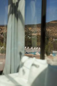 a window with a view of a pool and chairs at Valley View in Orderville