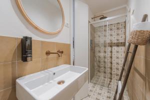 a bathroom with a white sink and a shower at Casa Ritunno Rooms in Favignana +28 photos
