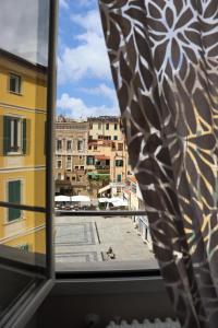a view of a city from a window at Sanremo Apartments - A Due Passi in Sanremo +14 photos