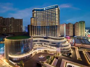 a view of a building in a city at night at Pullman Quanzhou Shuitou in Quanzhou