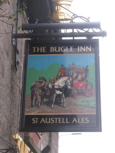 a sign hanging on the side of a building at The Bugle Inn in Bugle