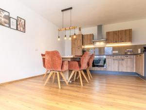 a kitchen and dining room with a table and chairs at Appart Zell in Zellberg +16 photos