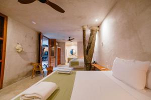 a bedroom with a white bed and a room with a bed at Hotel Boutique Alma Peregrina in Valladolid