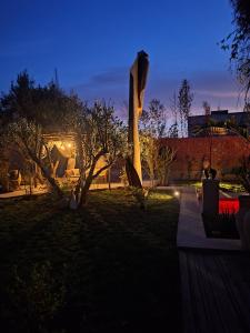 a person sitting on a bench in a garden at night at La villa de mamie in Dar Ito Lahssene