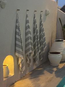 a wall with a bunch of towels hanging on it at Anıt Konak in Alaçatı