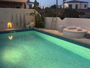 a swimming pool with a tub and a toilet in it at Anıt Konak in Alaçatı +76 photos