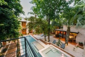 an aerial view of a house with a swimming pool and trees at Hotel Boutique Alma Peregrina in Valladolid +50 photos