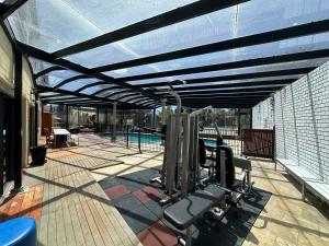 a patio with a gym with a swimming pool at Shine House in Balwyn North