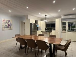 a kitchen and dining room with a wooden table and chairs at Shine House in Balwyn North