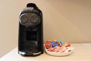 a black blender sitting next to a bowl of pins at Sanremo Apartments - A Due Passi in Sanremo