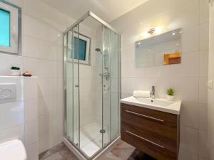 a bathroom with a glass shower and a sink at Jagerhütte in Mallnitz +48 photos