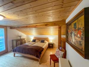 a bedroom with a large bed and a wooden ceiling at Jagerhütte in Mallnitz