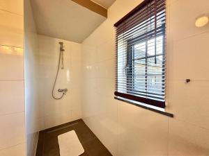 a bathroom with a shower and a window at Petit Wilogne in Houffalize +34 photos