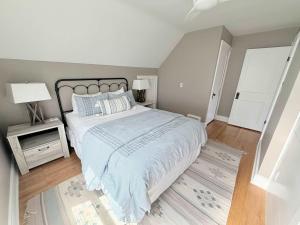a bedroom with a large bed with a blue comforter at The Catalog Cottage in Minocqua