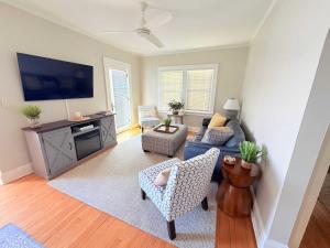 a living room with a couch and a tv at The Catalog Cottage in Minocqua +26 photos