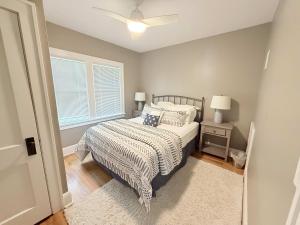a bedroom with a bed and a window at The Catalog Cottage in Minocqua