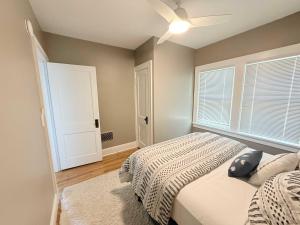 a bedroom with a bed and a ceiling fan at The Catalog Cottage in Minocqua