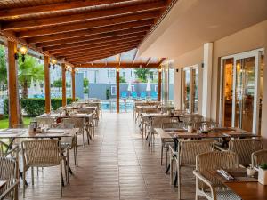 an empty restaurant with tables and chairs at Esperanza Hotel in Antalya