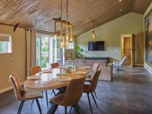 a dining room and living room with a table and chairs at Sientjeshof 1 in Diessen