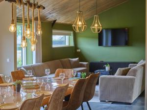 a dining room with a table and a couch at Sientjeshof 2 in Diessen