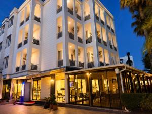 a large white building with a lot of windows at Esperanza Hotel in Antalya