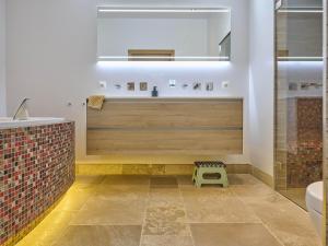 a bathroom with a tub and a sink and a mirror at De Binnenhof in Vriezenveen +75 photos