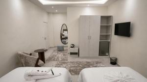 a white room with a bed and a mirror at Villa Golden Sunset Pyramids in Cairo