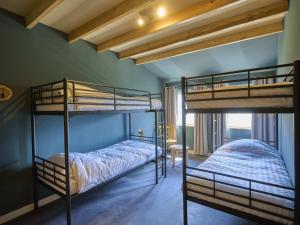 a bedroom with two bunk beds in a room at Sientjeshof 2 in Diessen