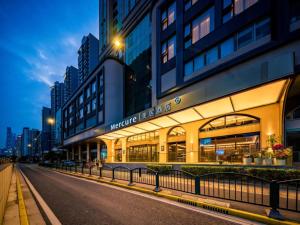 a building on a street in a city at night at Mercure Shanghai Lujiazui in Shanghai